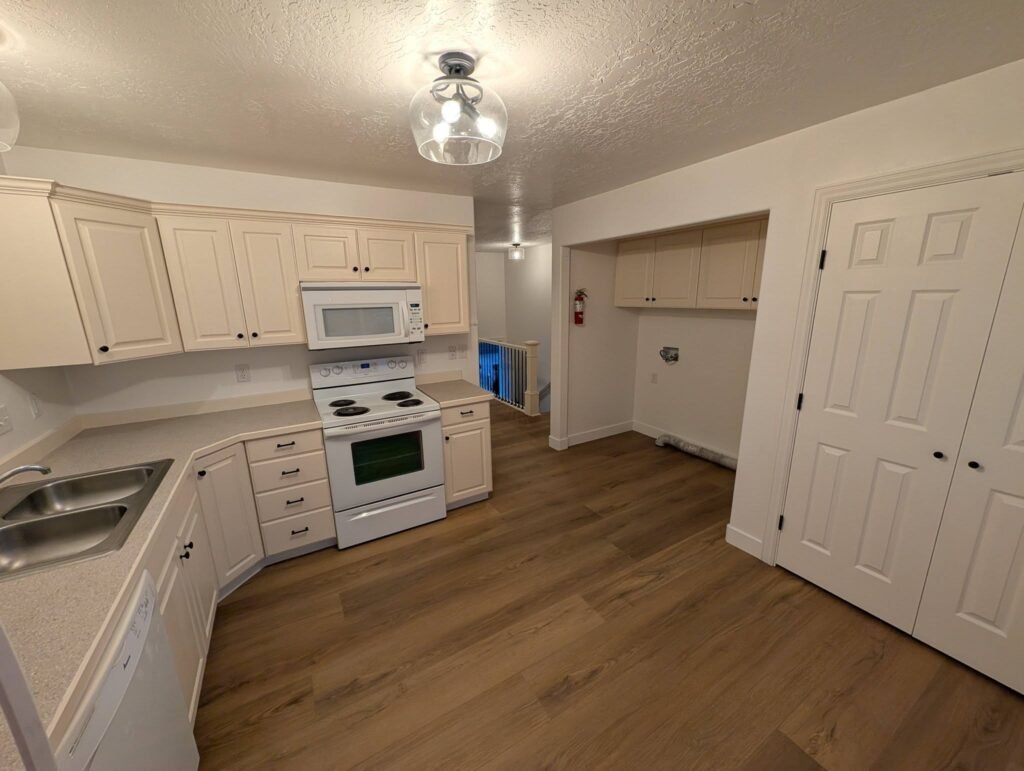 Finished refinished kitchen with updated flooring, lighting and hardware by The Nelsons Crew